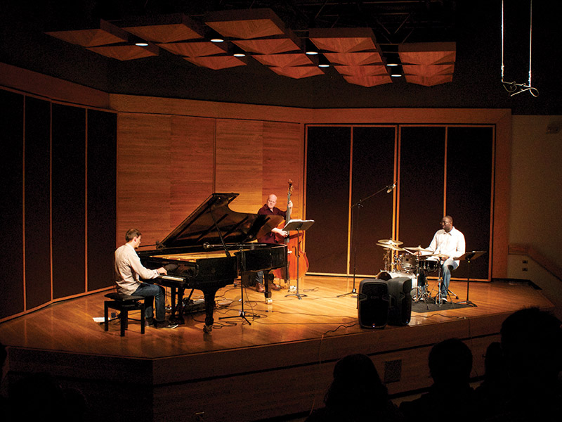 A pianist, bassist and drummer play a concert at the Lorne Watson Recital Hall, Brandon University, Brandon, Manitoba