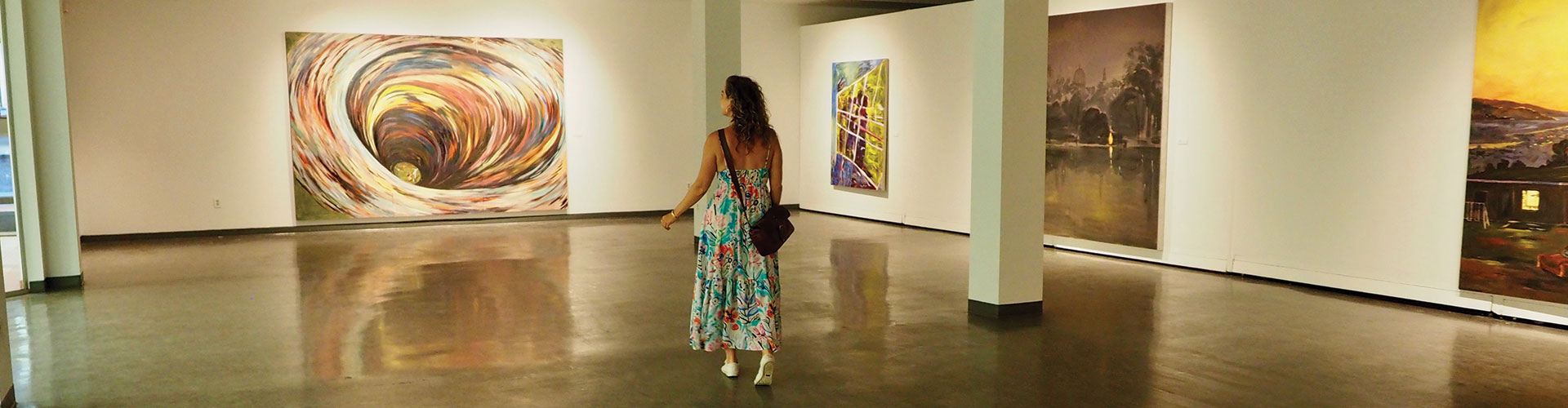 A visitor views the artwork in the main gallery of the Art Gallery of Southwestern Manitoba, Brandon