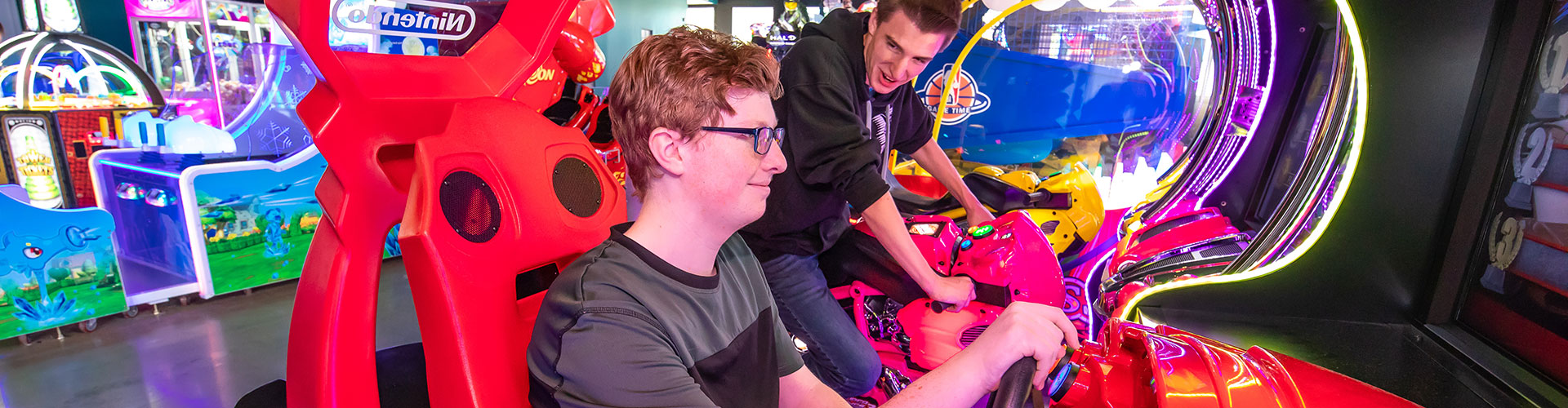 Two youths playing arcade games