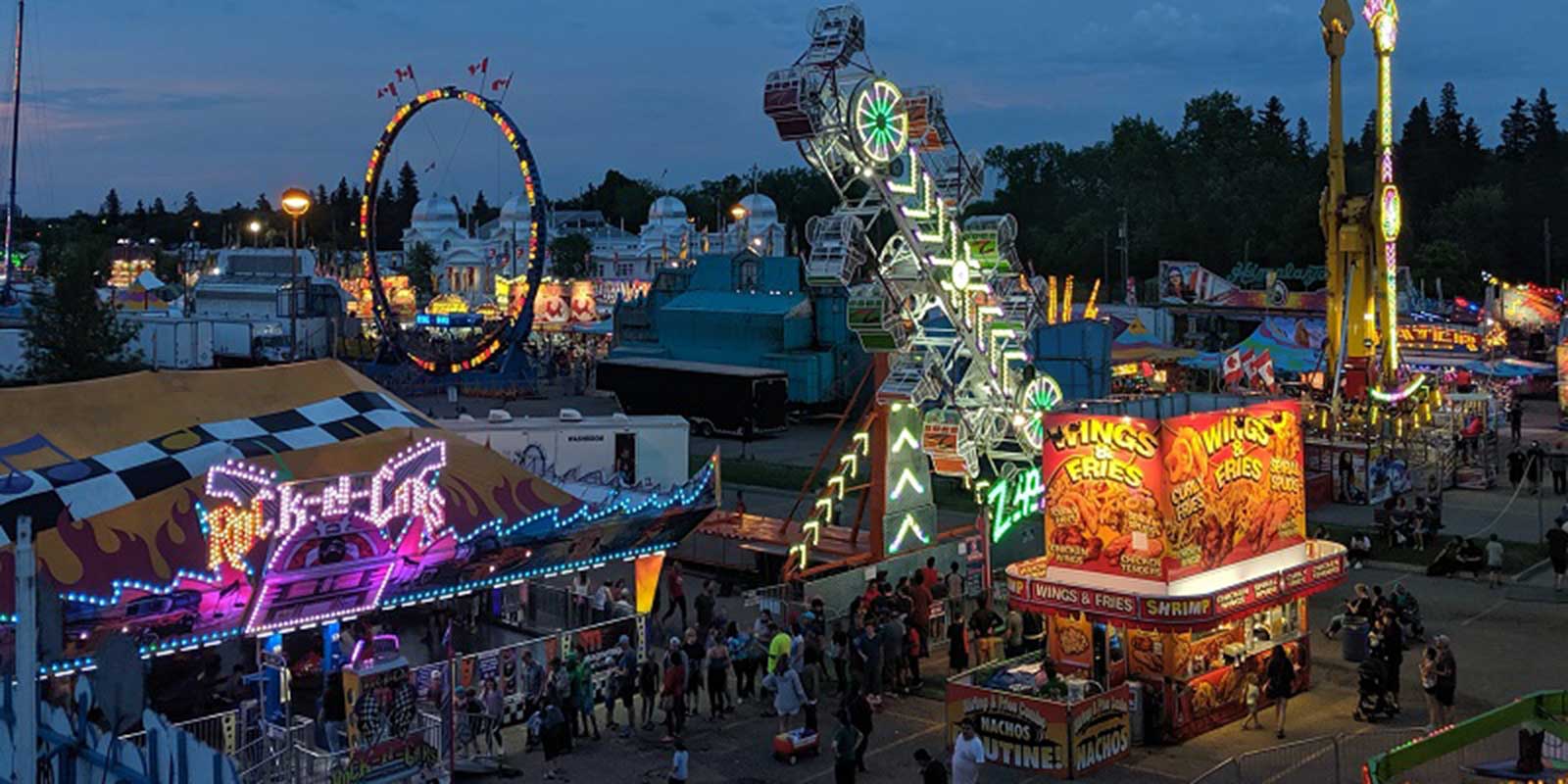 The midway at dusk at the Manitoba Summer Fair, Brandon, Manitoba